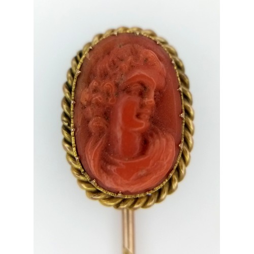 3 - A 15K GOLD STICK PIN WITH CARVED CORAL PICTURE OF A SATISFIED LADY .      2.6gms