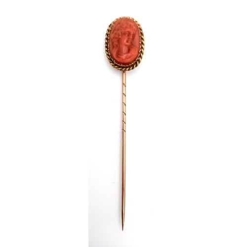 3 - A 15K GOLD STICK PIN WITH CARVED CORAL PICTURE OF A SATISFIED LADY .      2.6gms