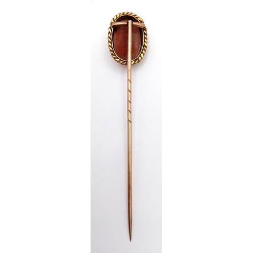 3 - A 15K GOLD STICK PIN WITH CARVED CORAL PICTURE OF A SATISFIED LADY .      2.6gms