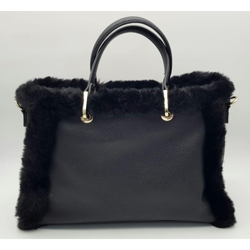 1518 - A Dune of London Handbag. Black textured exterior with gold tone hardware. Faux fur interior lining.... 