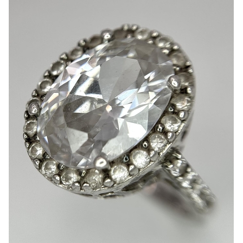 1502 - A fabulous 925 silver ring with large CZ centre and surrounding by stone & shoulders. Total weight 6... 