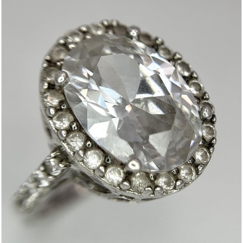 1502 - A fabulous 925 silver ring with large CZ centre and surrounding by stone & shoulders. Total weight 6... 