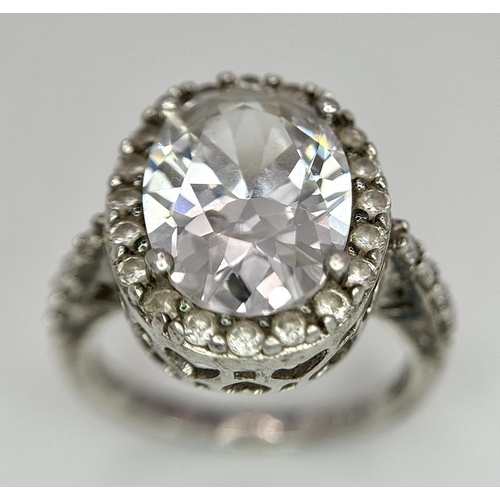 1502 - A fabulous 925 silver ring with large CZ centre and surrounding by stone & shoulders. Total weight 6... 