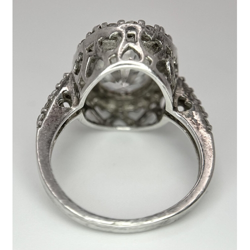 1502 - A fabulous 925 silver ring with large CZ centre and surrounding by stone & shoulders. Total weight 6... 