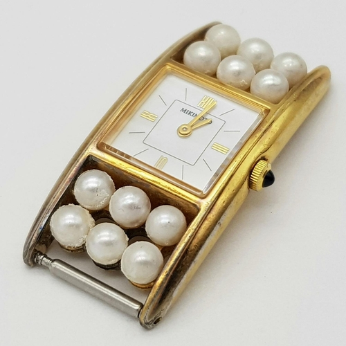 498 - A Mikimoto Gold plated Sterling Silver Watch Case with Pearl Decoration. Quartz movement. In need of... 