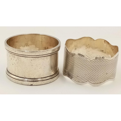 528 - Two Antique Hallmarked Silver Napkin Rings Comprising 1) An engine turned wave design Dated 1858/9 a... 