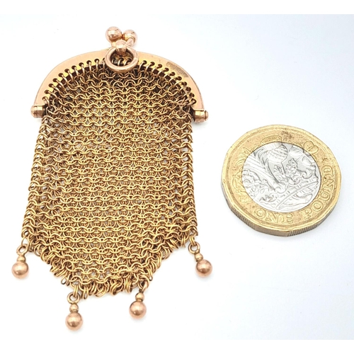 599 - An antique yellow metal change purse. 7 X 4cm.