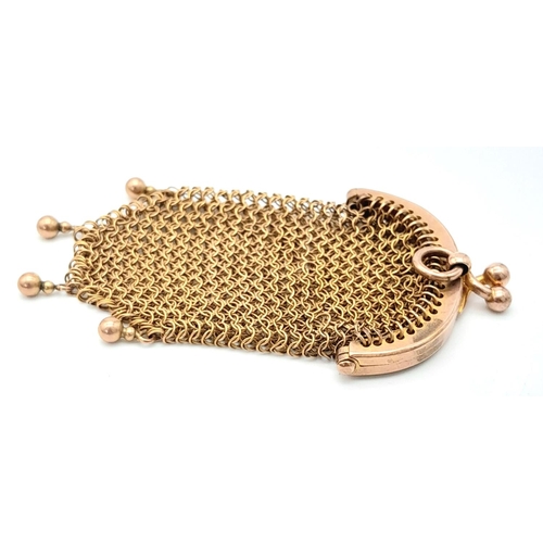 599 - An antique yellow metal change purse. 7 X 4cm.