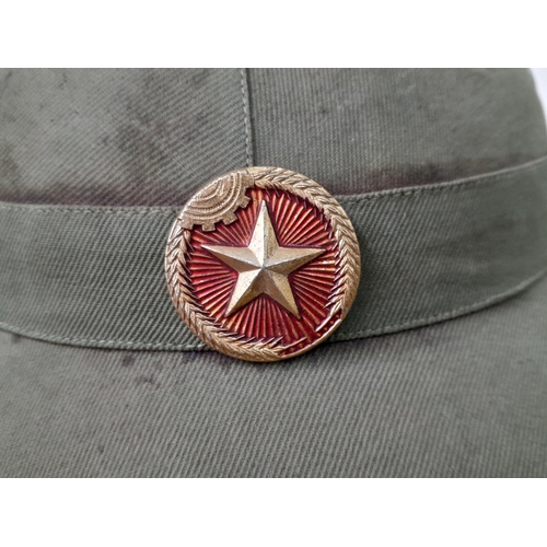 627 - WW2 Vietnam War Era North Vietnamese Army (NVA) Fiber Helmet with liner and cap and badge.