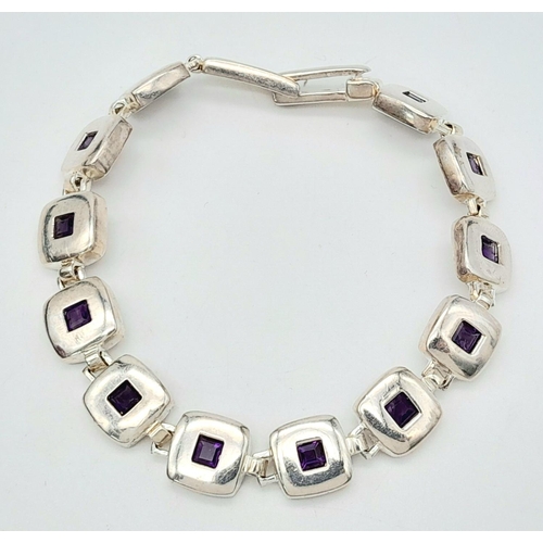 633 - A Vintage Sterling Silver Modernist Design Amethyst Set Tennis Bracelet 19.5cm Length. 18.07 Grams.