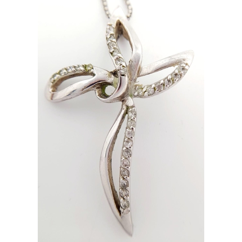 634 - A fancy 925 silver stone set cross pendant on silver box chain. Total weight 6.2G. Total length 43 c... 