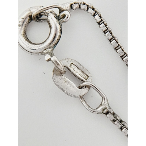 634 - A fancy 925 silver stone set cross pendant on silver box chain. Total weight 6.2G. Total length 43 c... 