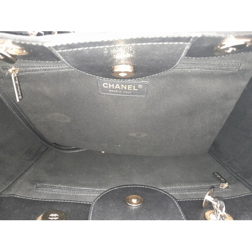 290 - A Chanel Deauville Tote Bag. Black leather exterior with gold tone hardware. Chanel, Paris silver to... 