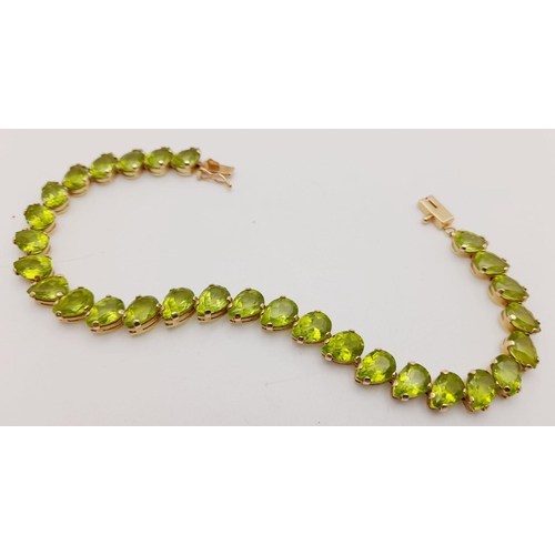 167 - Beautiful 9 carat GOLD BRACELET set with 29 x PEAR CUT PERIDOT GEMSTONES. 9.6 grams. 18.5 cm.