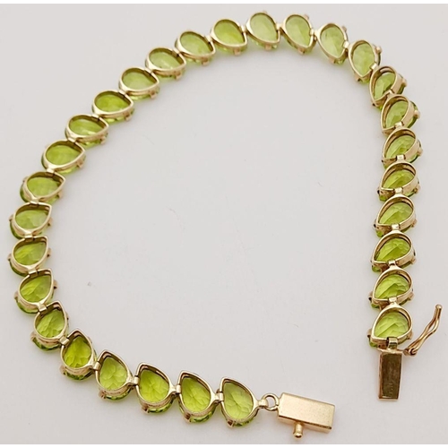 167 - Beautiful 9 carat GOLD BRACELET set with 29 x PEAR CUT PERIDOT GEMSTONES. 9.6 grams. 18.5 cm.