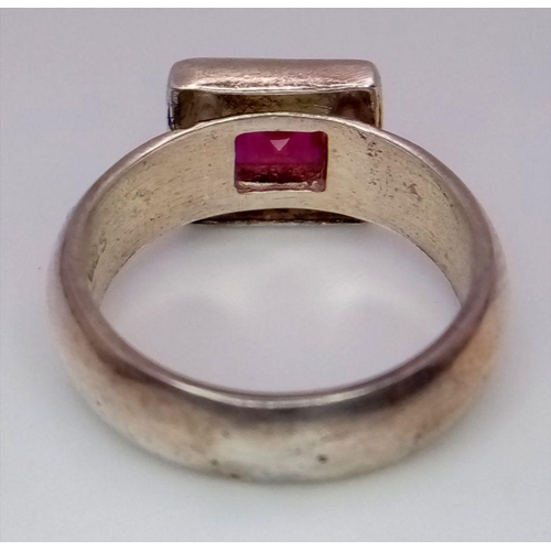 223 - Vintage SILVER and RUBY RING. Having a square cut Ruby in a SILVER FRAME mount. Complete with ring b... 