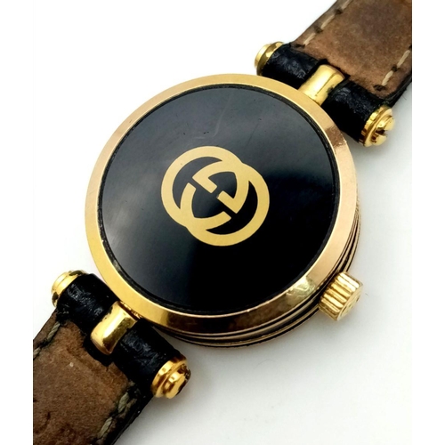 491 - A Designer Gucci Ladies Quartz Watch. Black leather strap with original Gucci clasp. Gold plated and... 