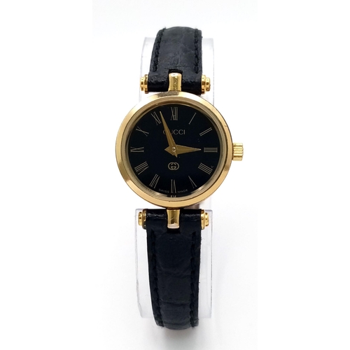 491 - A Designer Gucci Ladies Quartz Watch. Black leather strap with original Gucci clasp. Gold plated and... 