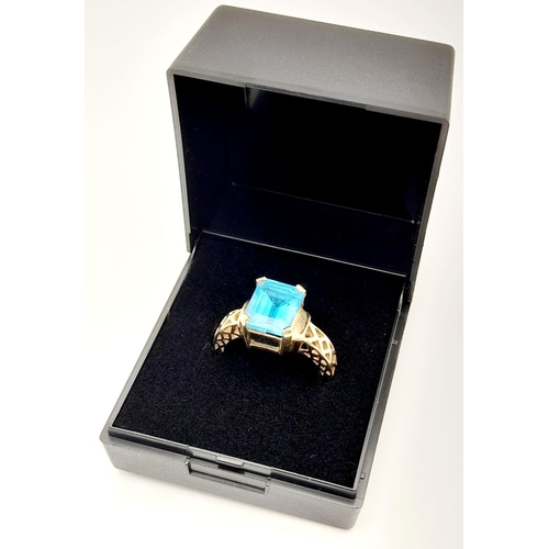 174 - Impressive 9 carat GOLD and SWISS BLUE TOPAZ RING. Having an Emerald cut 3.38 carat Blue Topaz Solit... 