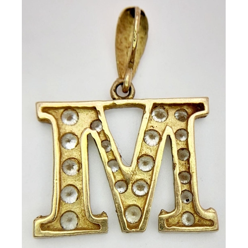 410 - A 9K Yellow Gold (tested as) CZ Set ‘M’ Pendant. 3.9g in total weight.