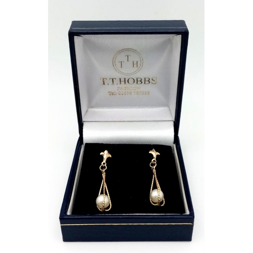 623 - Classic pair of 9 carat GOLD, CAGED PEARL EARRINGS. Drop style with attractive FLEUR DE LYS detail t... 