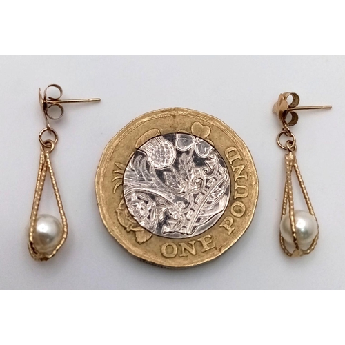 623 - Classic pair of 9 carat GOLD, CAGED PEARL EARRINGS. Drop style with attractive FLEUR DE LYS detail t... 