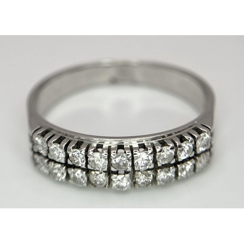 596 - An 18K White Gold and Two Row Diamond Ring. 18 brilliant round cut diamonds - 0.90ctw. Size Q. 4.4g ... 