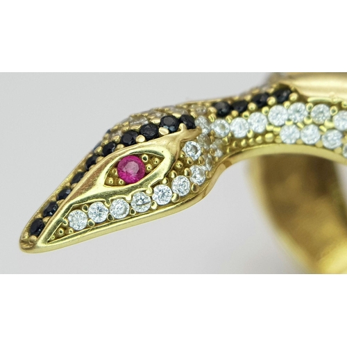 508 - A Tempting 18K Yellow Gold, Sapphire and Diamond Serpent Ring. This ruby eyed reptile will coil arou... 