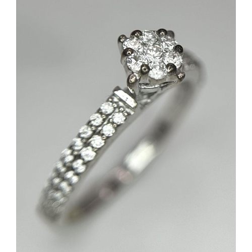 561 - Two 18K White Gold and Diamond Rings. An 18K White gold and diamond cluster ring - size M. An 18K wh... 