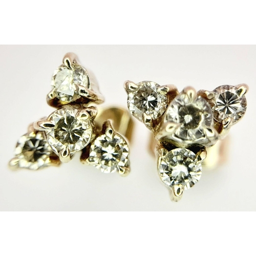 617 - A Pair of 18K Yellow Gold, Four Diamond Stud Earrings. Eight round cut diamonds in trillion form. 2.... 