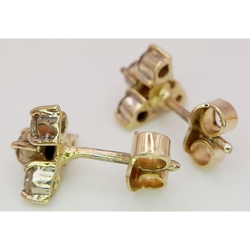 617 - A Pair of 18K Yellow Gold, Four Diamond Stud Earrings. Eight round cut diamonds in trillion form. 2.... 