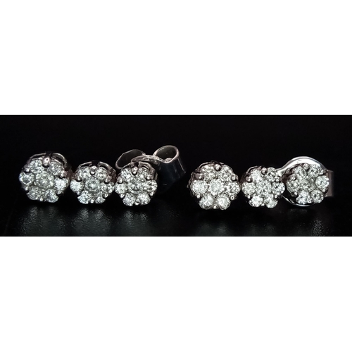 638 - A Pair of 18K White Gold and Diamond Drop Earrings. Graduating floral clusters. 12mm drop. 2.5g tota... 