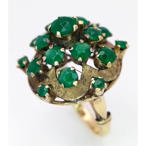 10 - A Vintage 14k Yellow Gold Emerald Ring. 20 graduating emeralds in circular floral form. Size L 1/2. ... 