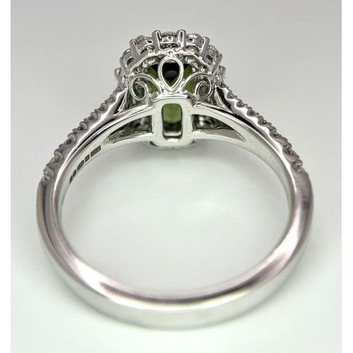 116 - An 18K White Gold Green Tourmaline Ring. Rectangular 1.63ct tourmaline with a sophisticated diamond ... 