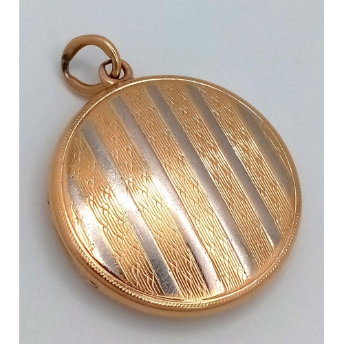 24 - A Vintage 18k Yellow and White Gold (tested) Locket Pendant. Circular form with vertical white lines... 