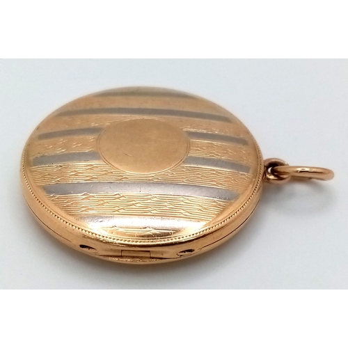 24 - A Vintage 18k Yellow and White Gold (tested) Locket Pendant. Circular form with vertical white lines... 