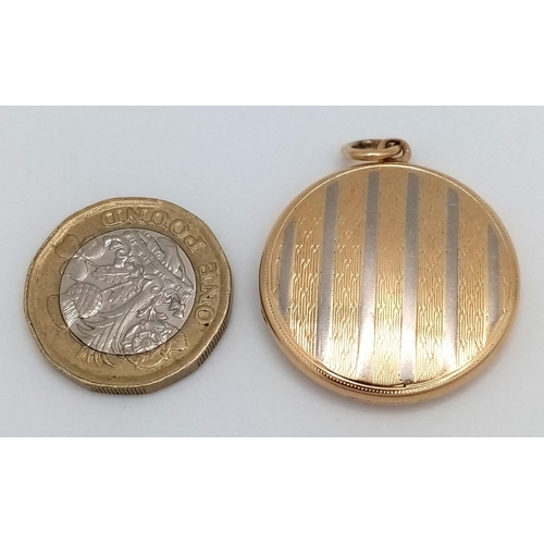 24 - A Vintage 18k Yellow and White Gold (tested) Locket Pendant. Circular form with vertical white lines... 