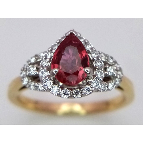 32 - An 18K White and Yellow Gold Ruby and Diamond Ring. 0.75ct pear-shaped central ruby with a diamond s... 