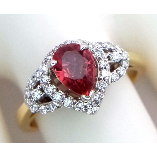 32 - An 18K White and Yellow Gold Ruby and Diamond Ring. 0.75ct pear-shaped central ruby with a diamond s... 