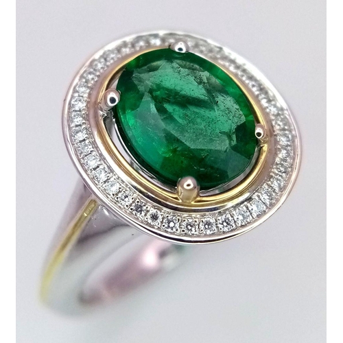 39 - An 18K White Gold, Emerald and Diamond Ring. A hypnotic 2ct oval cut central green emerald with a 0.... 