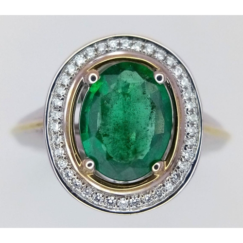 39 - An 18K White Gold, Emerald and Diamond Ring. A hypnotic 2ct oval cut central green emerald with a 0.... 