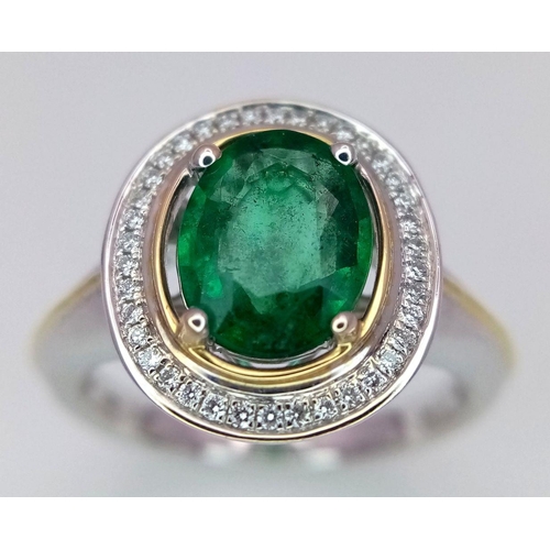 39 - An 18K White Gold, Emerald and Diamond Ring. A hypnotic 2ct oval cut central green emerald with a 0.... 