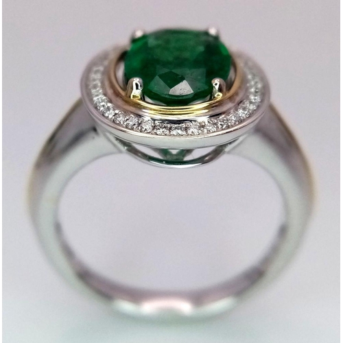 39 - An 18K White Gold, Emerald and Diamond Ring. A hypnotic 2ct oval cut central green emerald with a 0.... 