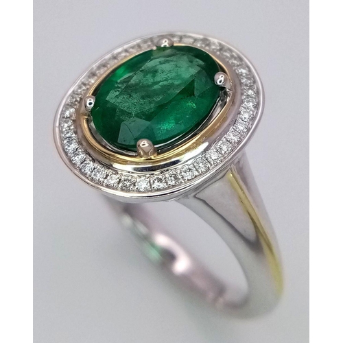 39 - An 18K White Gold, Emerald and Diamond Ring. A hypnotic 2ct oval cut central green emerald with a 0.... 