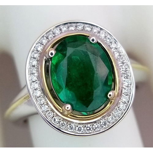 39 - An 18K White Gold, Emerald and Diamond Ring. A hypnotic 2ct oval cut central green emerald with a 0.... 