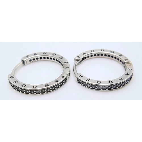 1225 - A pair of 925 silver Pandora stone set hoop earrings. Total weight 3.45G.