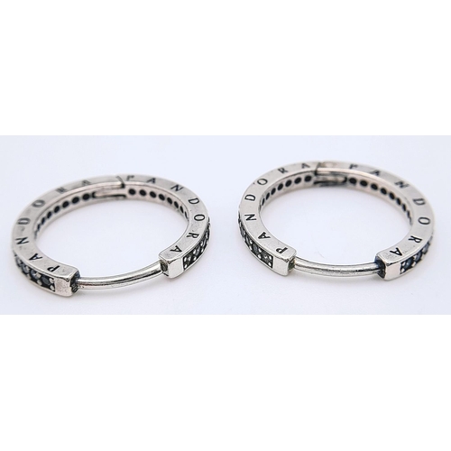 1225 - A pair of 925 silver Pandora stone set hoop earrings. Total weight 3.45G.