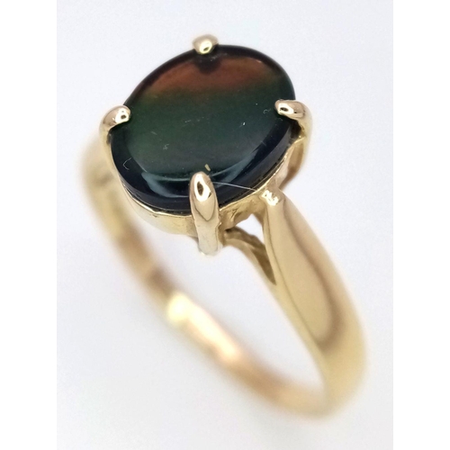 101 - A 14K Yellow Gold and Mystic Topaz Ring. Oval cut centre stone. Size O. 2.57g total weight.