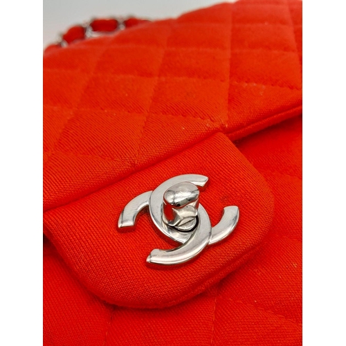 12 - A Chanel Red Jersey Quilted Double Flap Bag. Diamond quilted jersey knit fabric in red, silver-toned... 