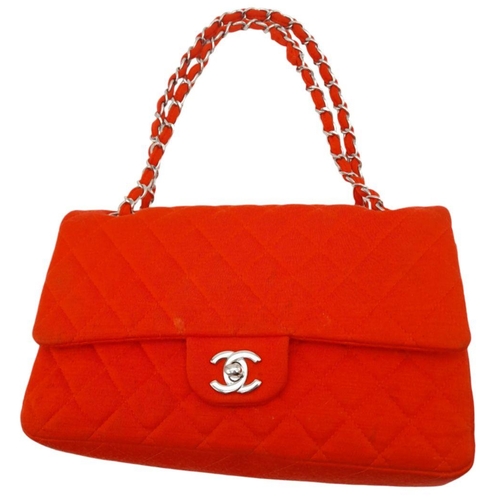 12 - A Chanel Red Jersey Quilted Double Flap Bag. Diamond quilted jersey knit fabric in red, silver-toned... 